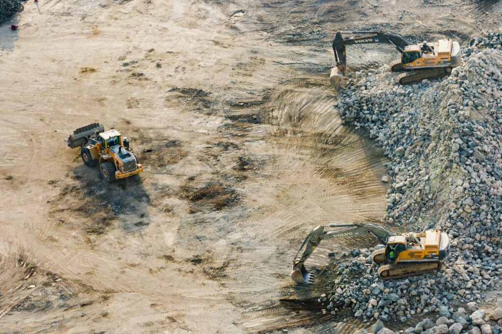 pexels-photo-1238864 Three Yellow Excavators Near Front End Loader